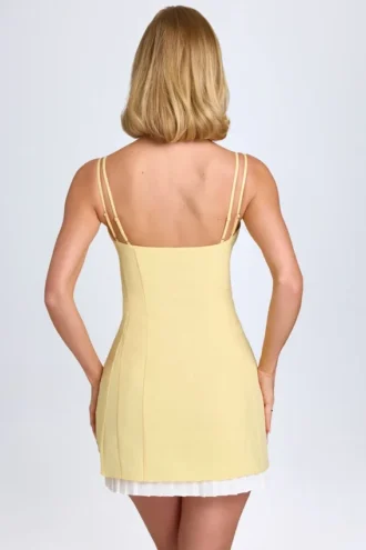 Bronwyn minijurk met strikdetail en plooien in pastelgeel