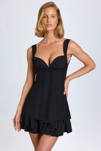 Cassandra minijurk met ruches en knoopdetails in zwart