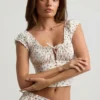 Faela gerimpelde katoen-popeline corset top met rozenprint