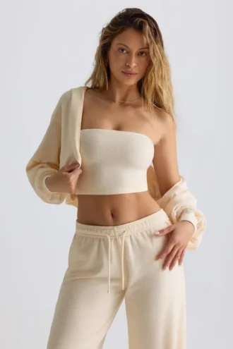 Geborsteld jersey cropped bolero met capuchon in ecru