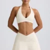 Geborstelde jersey mini-skort met gekruiste banden in ivoormelange