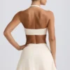 Geborstelde jersey mini-skort met gekruiste banden in ivoormelange