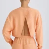 Getextureerd katoenen jersey cropped sweatshirt met open rug in perzik