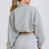 Korte sweater met kwartritssluiting in grijs gemêleerd
