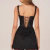 Lia minijurk met vetersluiting en drapering in zwart