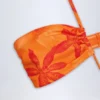 Maranta halternekbadpak met uitsnijdingen in oranje orchideeënprint