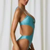 Melo Melo halternekbadpak met parelversiering en uitsnijdingen in turquoise
