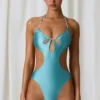 Melo Melo halternekbadpak met parelversiering en uitsnijdingen in turquoise