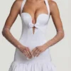 Millie minijurk met strikdetail, halternek en bolle zoom in wit