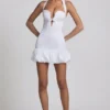Millie minijurk met strikdetail, halternek en bolle zoom in wit