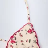 Noia micro-triangel bikinitop met rode bloemenprint