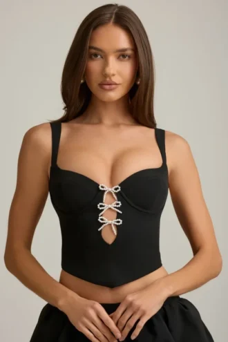 Pearla korset-top met uitsnijdingen en strikdetail in zwart