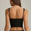 Pearla korset-top met uitsnijdingen en strikdetail in zwart