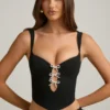 Pearla korset-top met uitsnijdingen en strikdetail in zwart
