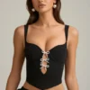 Pearla korset-top met uitsnijdingen en strikdetail in zwart