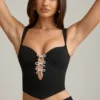 Pearla korset-top met uitsnijdingen en strikdetail in zwart