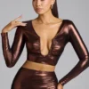 Rana crop top met diepe halslijn van metallic jersey in koperbrons