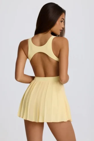 Soft Active tennisjurk met open rug en plooien in Lemon